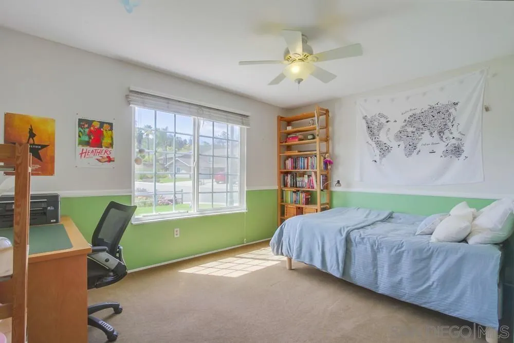 13202 Lingre Avenue Poway, CA 92064 - Photo 47 of 71 a bedroom with a bed and a chandelier