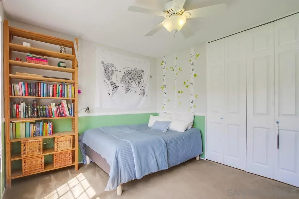 13202 Lingre Avenue Poway, CA 92064 - Photo 48 of 71 a bedroom with a bed and a book shelf