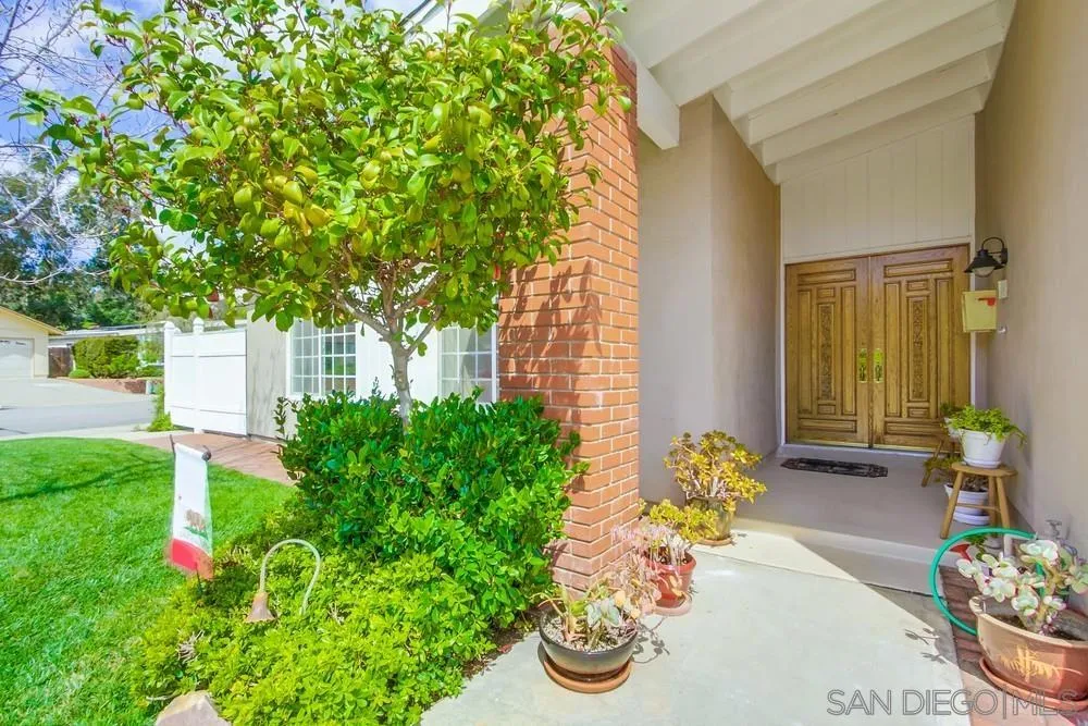 13202 Lingre Avenue Poway, CA 92064 - Photo 9 of 71 a front view of a house with lots of flower plants