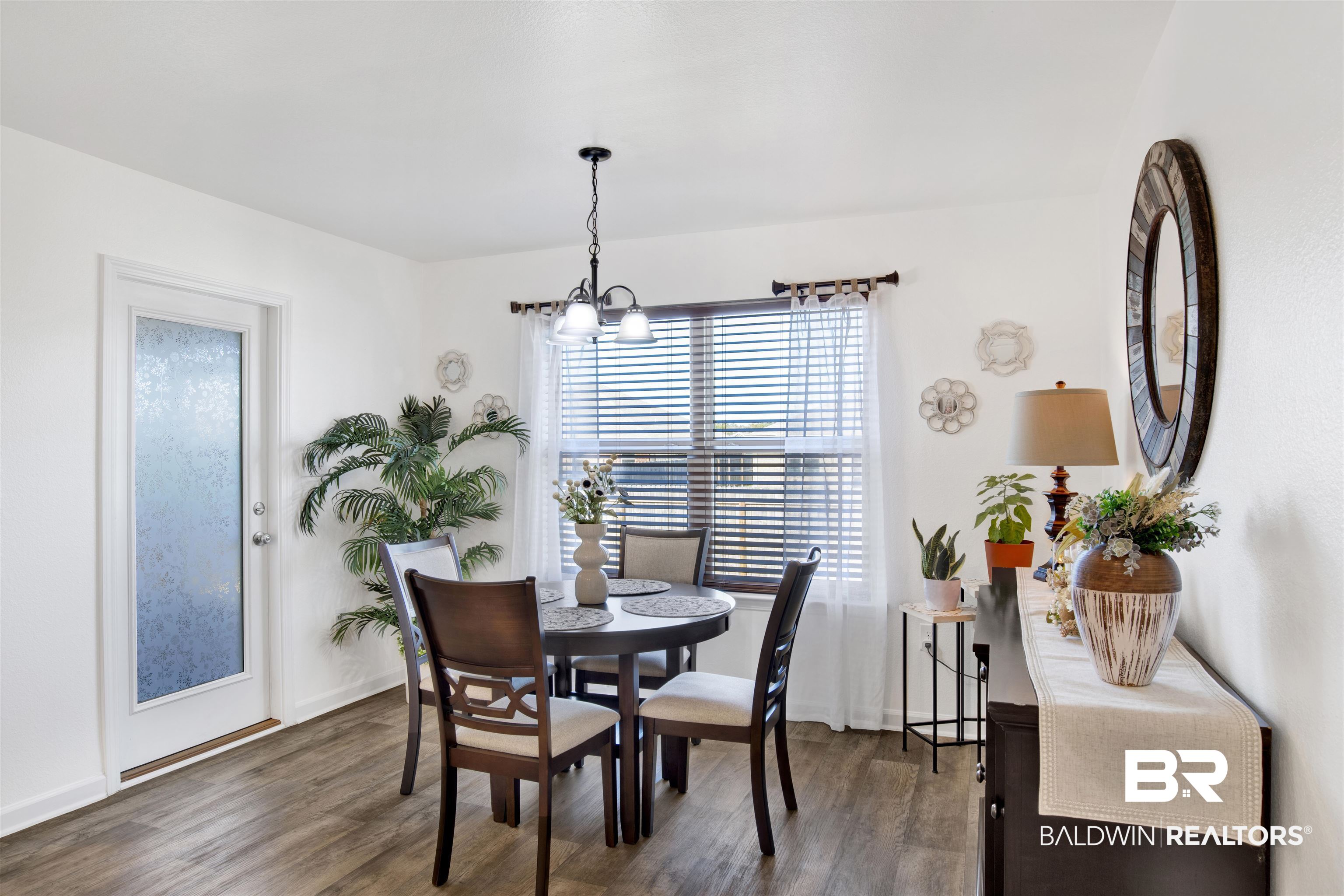 8102 Irwin Loop Daphne, AL 36526 - Photo 12 of 30 Dining space featuring dark wood-type flooring and a chandelier