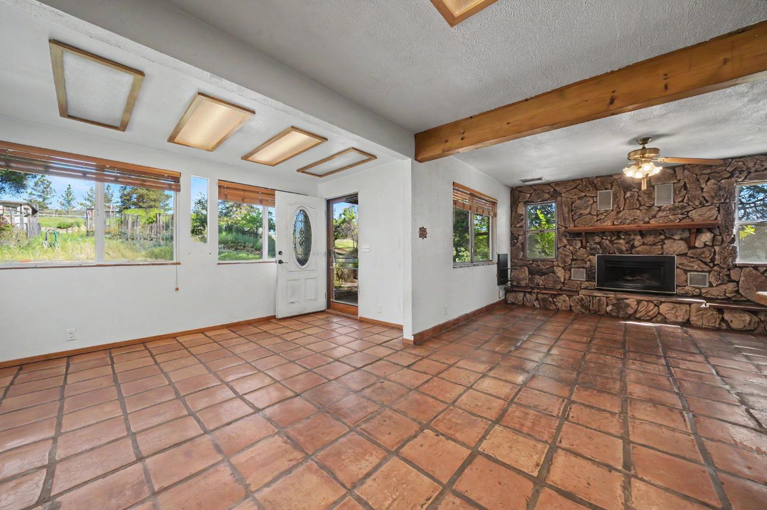17800 Red Mule Road Fiddletown, CA 95629 - Photo 13 of 74 a view of empty room with fireplace and windows