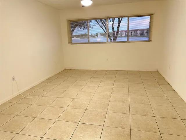 an empty room with white walls and tiles