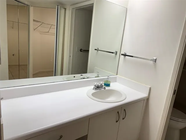 an empty room with a fireplace and chandelier