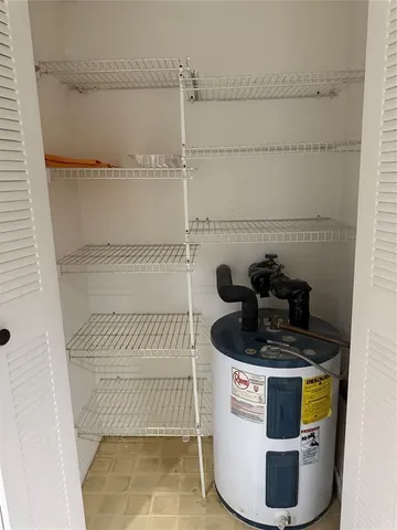 a view of tree next to a lake with large trees