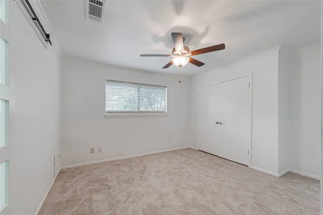 a view of a big room with a chandelier fan and windows
