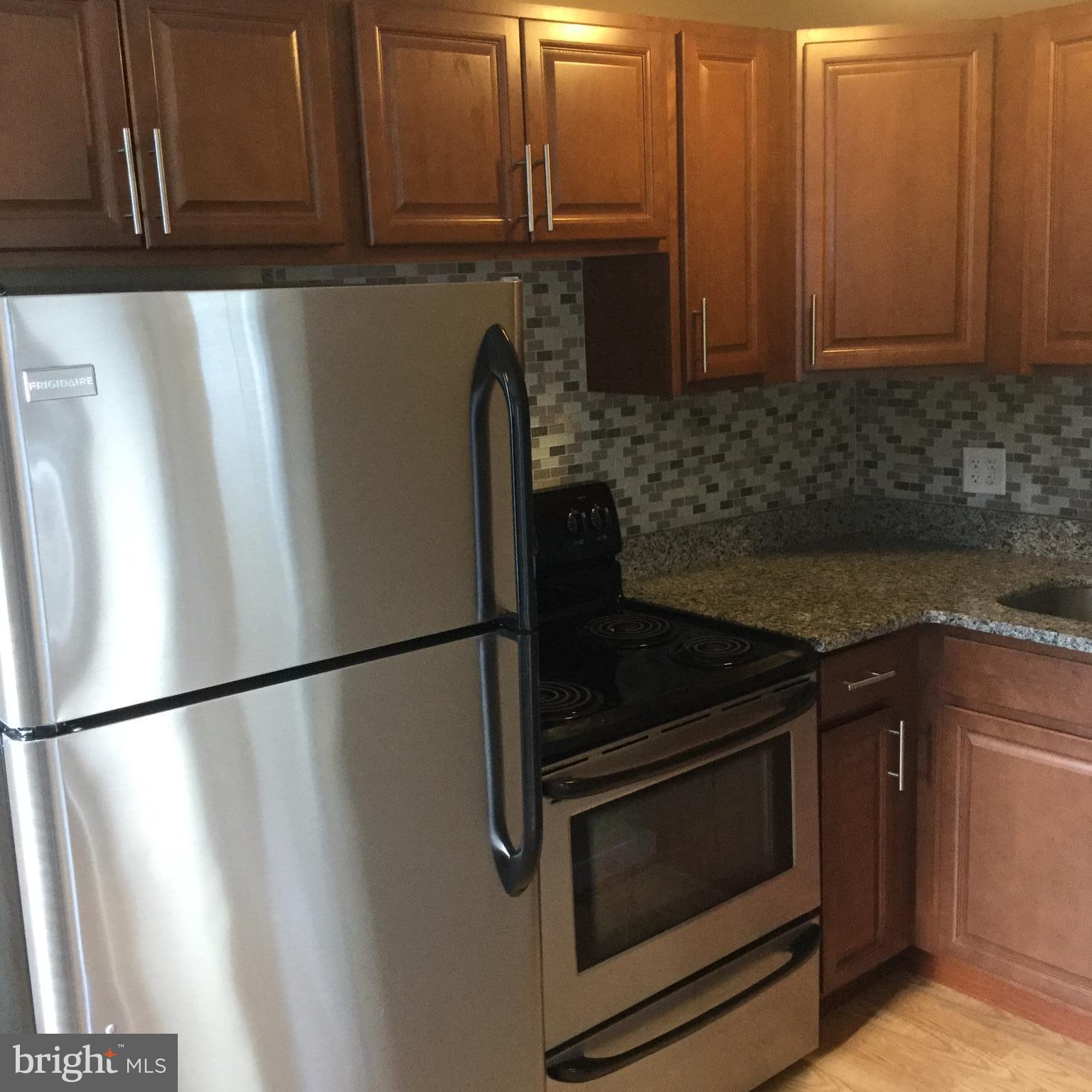 1725 Light Street Baltimore, MD 21230 - Photo 1 of 10 a kitchen with granite countertop cabinets and steel stainless steel appliances