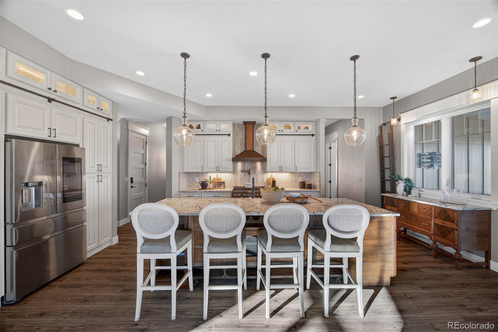 3444 Antelope Ridge Trail Parker, CO 80138 - Photo 13 of 50 a large kitchen with a table and chairs