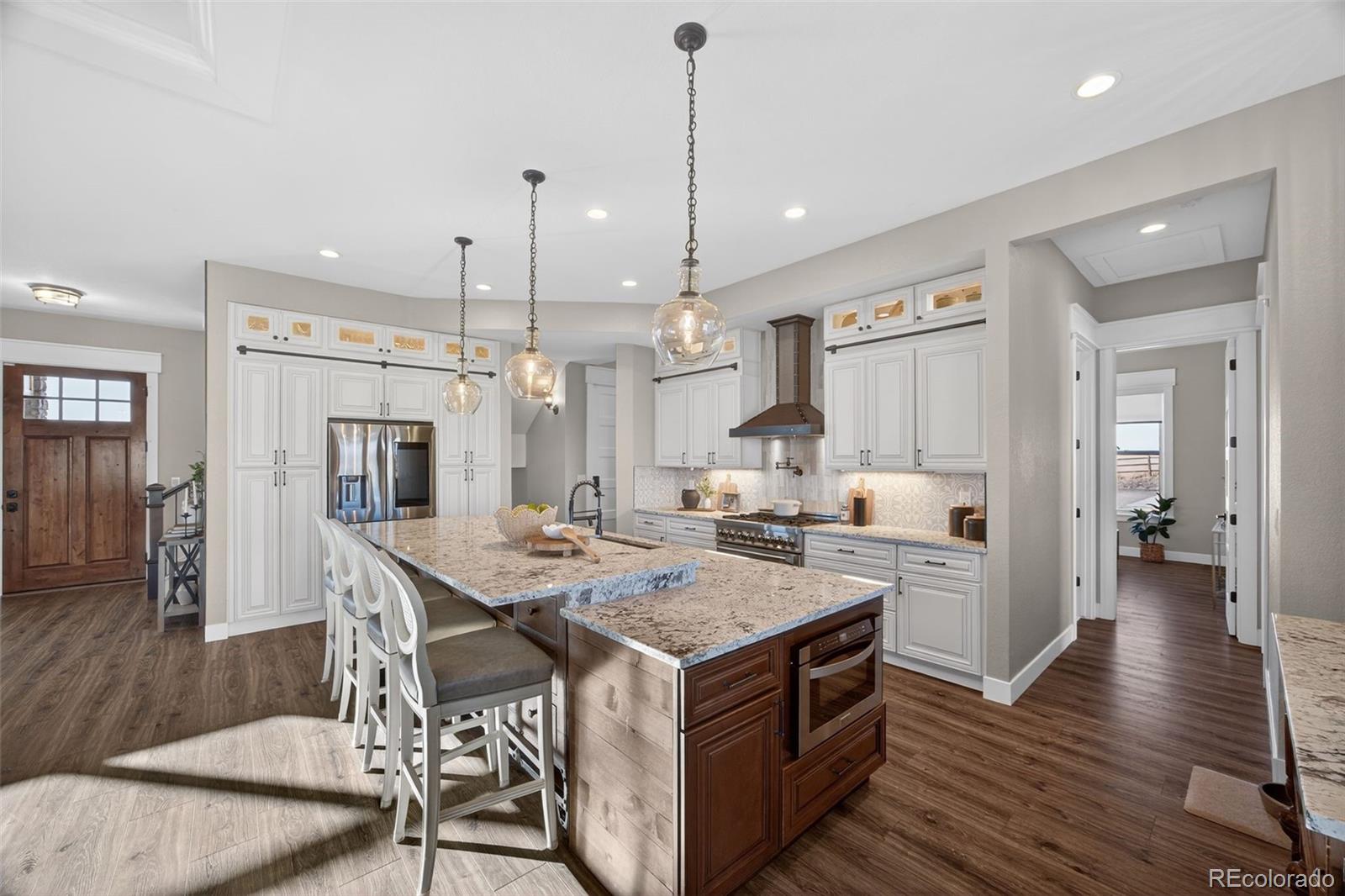 3444 Antelope Ridge Trail Parker, CO 80138 - Photo 14 of 50 a kitchen with a stove a refrigerator and a wooden floor