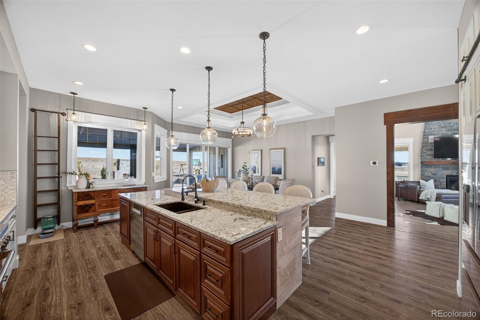3444 Antelope Ridge Trail Parker, CO 80138 - Photo 15 of 50 a kitchen with a stove and wooden floor
