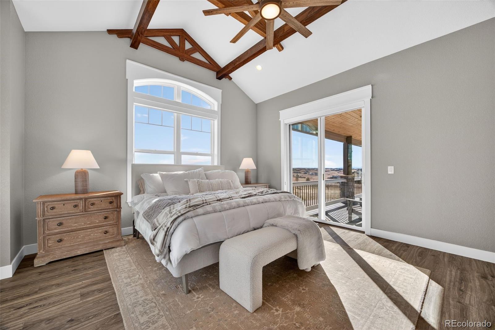 3444 Antelope Ridge Trail Parker, CO 80138 - Photo 21 of 50 a spacious bedroom with a bed and a lamp