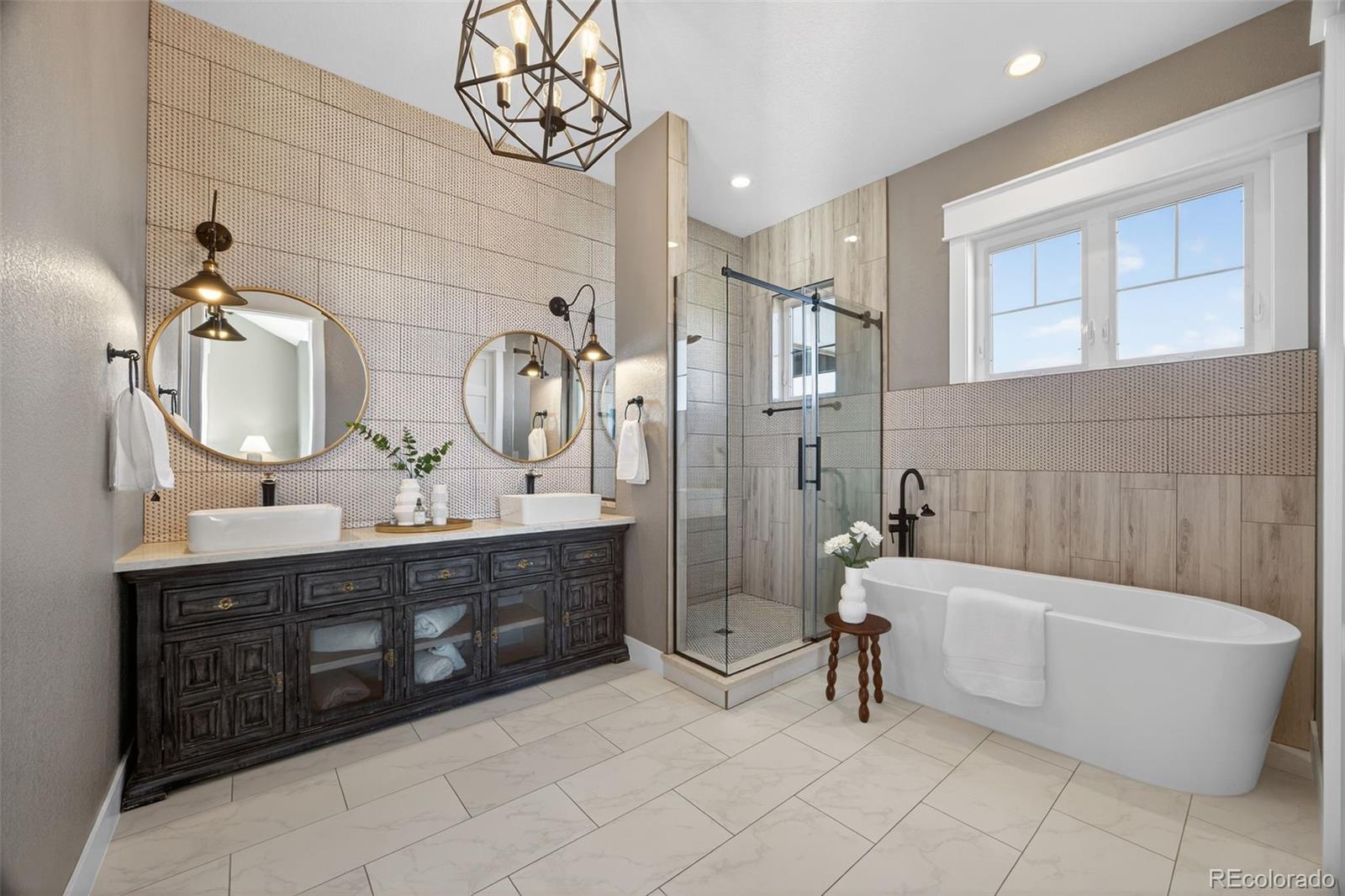 3444 Antelope Ridge Trail Parker, CO 80138 - Photo 22 of 50 a bathroom with a tub a double vanity sink and a mirror