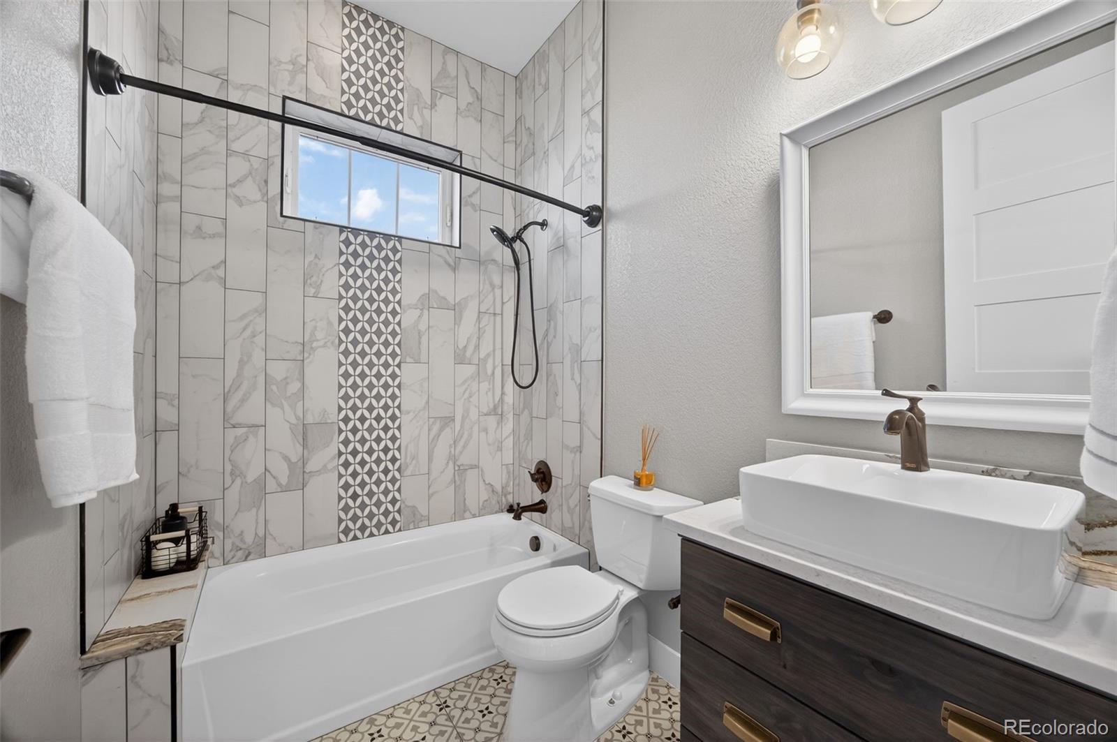 3444 Antelope Ridge Trail Parker, CO 80138 - Photo 25 of 50 a bathroom with a sink a toilet and shower