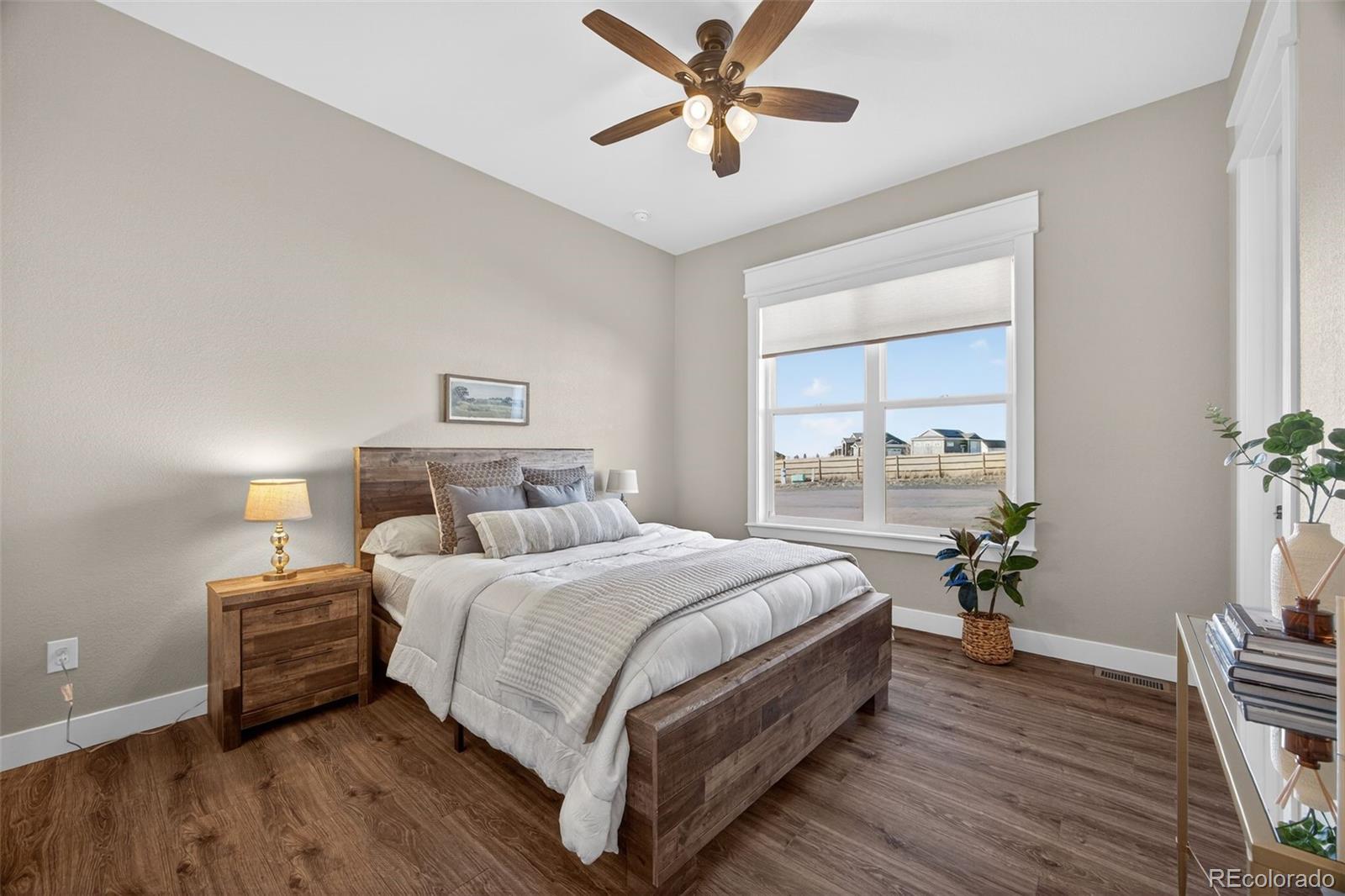 3444 Antelope Ridge Trail Parker, CO 80138 - Photo 26 of 50 a bedroom with a bed table and a window