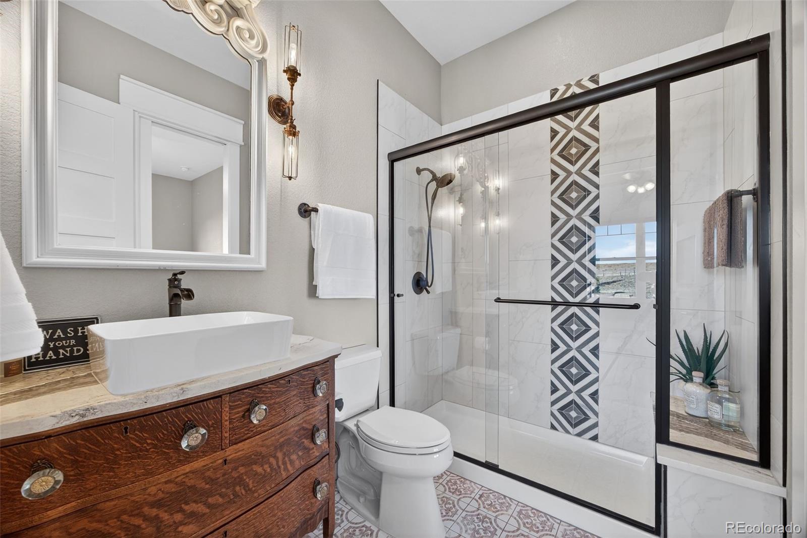 3444 Antelope Ridge Trail Parker, CO 80138 - Photo 27 of 50 a bathroom with a sink a toilet and shower