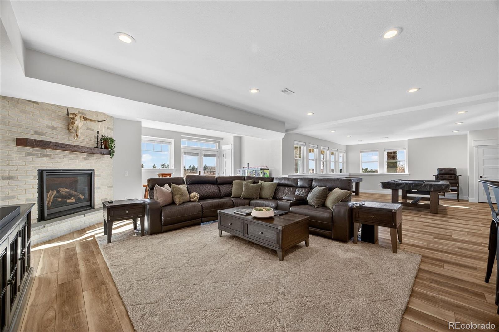 3444 Antelope Ridge Trail Parker, CO 80138 - Photo 31 of 50 a living room with furniture and a fireplace
