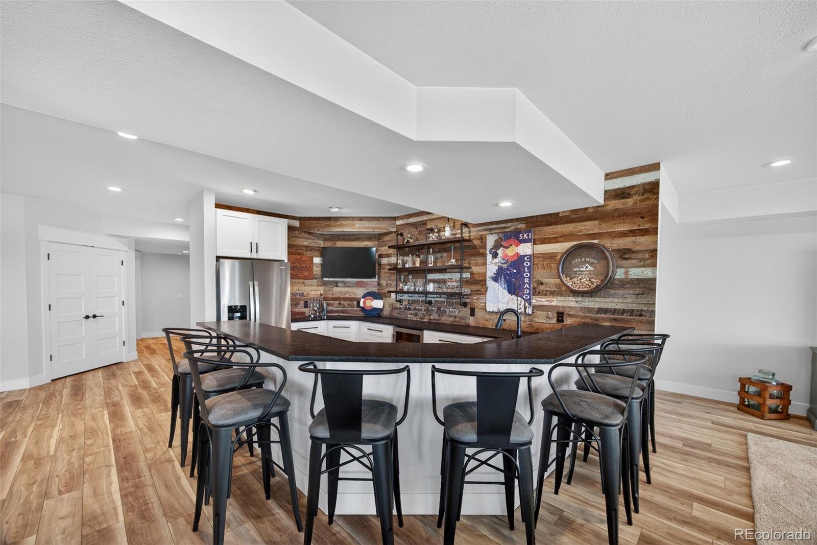 3444 Antelope Ridge Trail Parker, CO 80138 - Photo 32 of 50 a view of a dining room with furniture and wooden floor