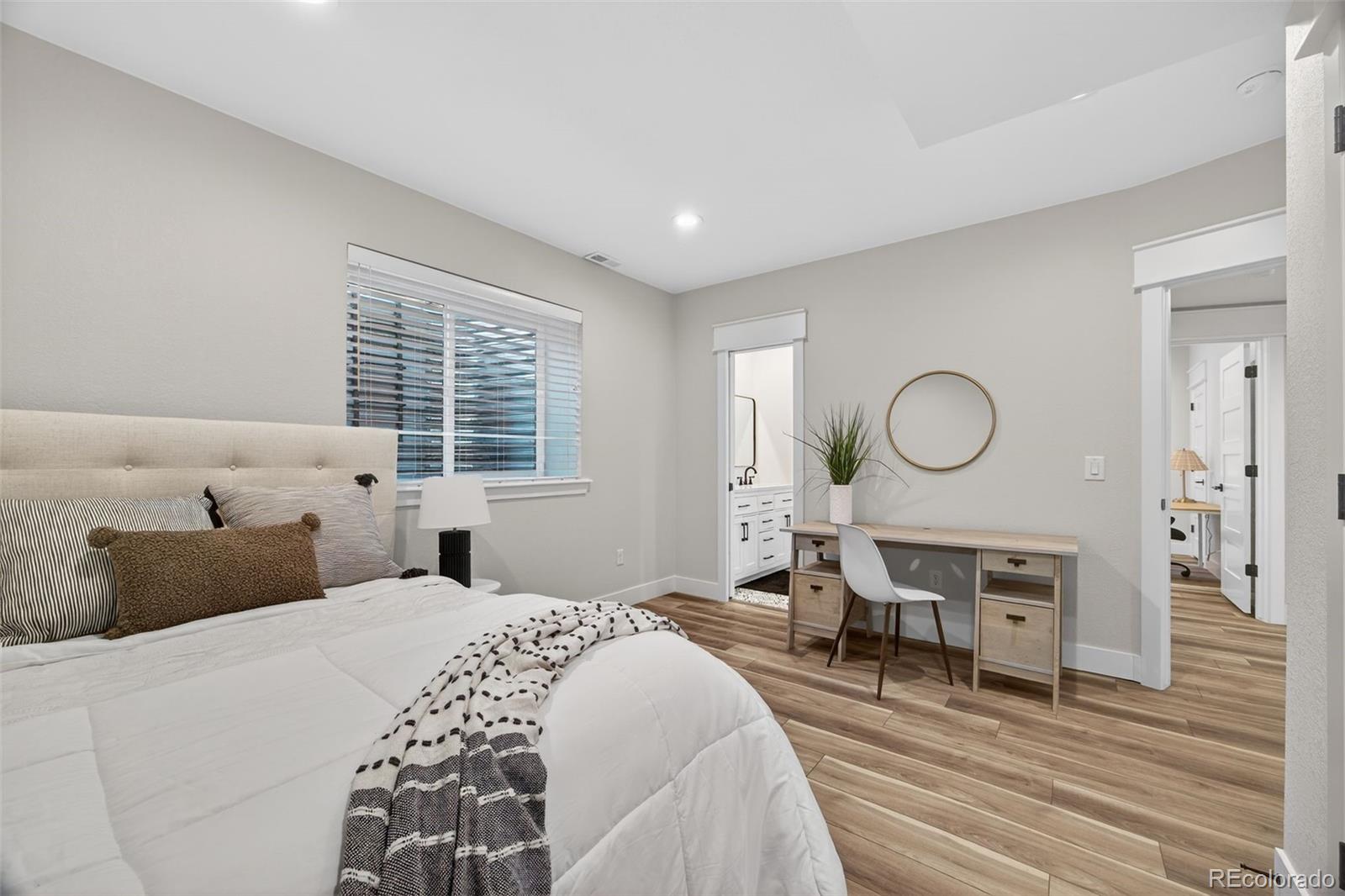 3444 Antelope Ridge Trail Parker, CO 80138 - Photo 37 of 50 a bedroom with bed and wooden floor