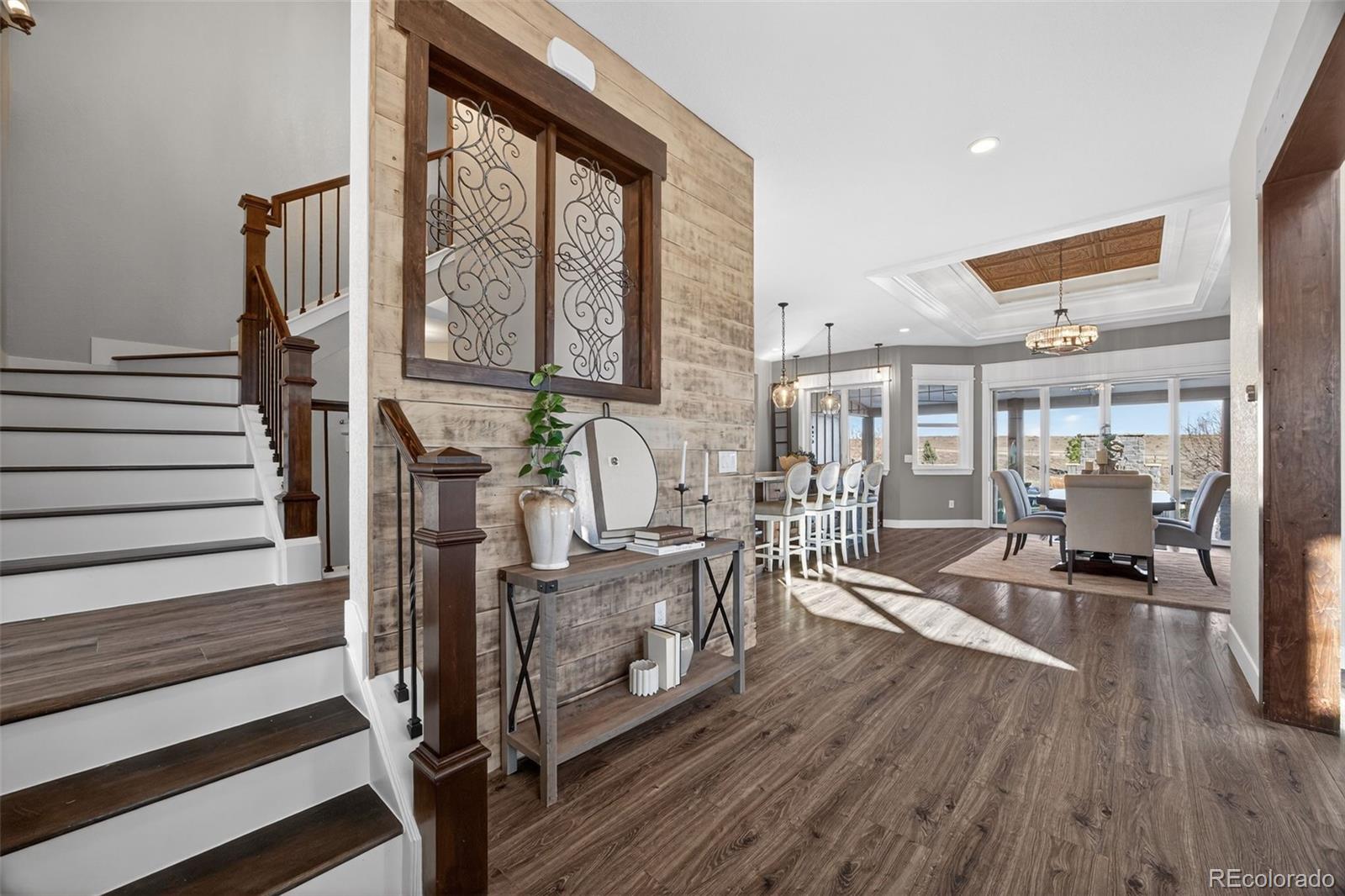 3444 Antelope Ridge Trail Parker, CO 80138 - Photo 6 of 50 a living room with furniture large windows and wooden floor
