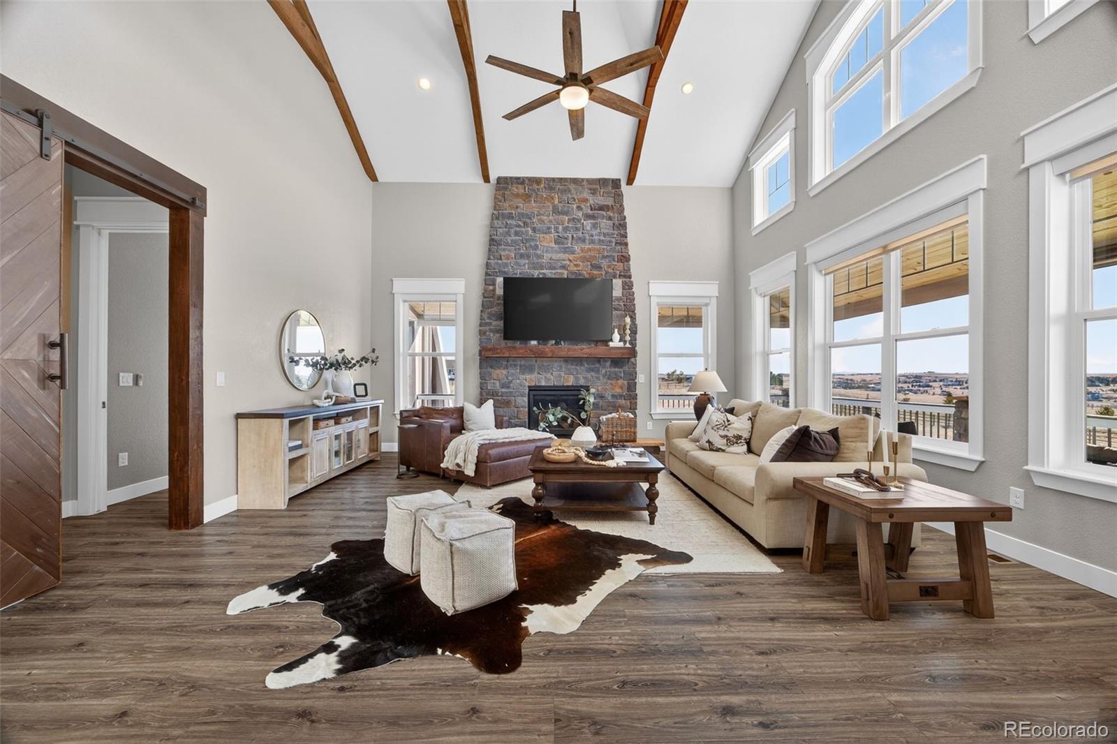 3444 Antelope Ridge Trail Parker, CO 80138 - Photo 7 of 50 a living room with furniture fireplace and a table