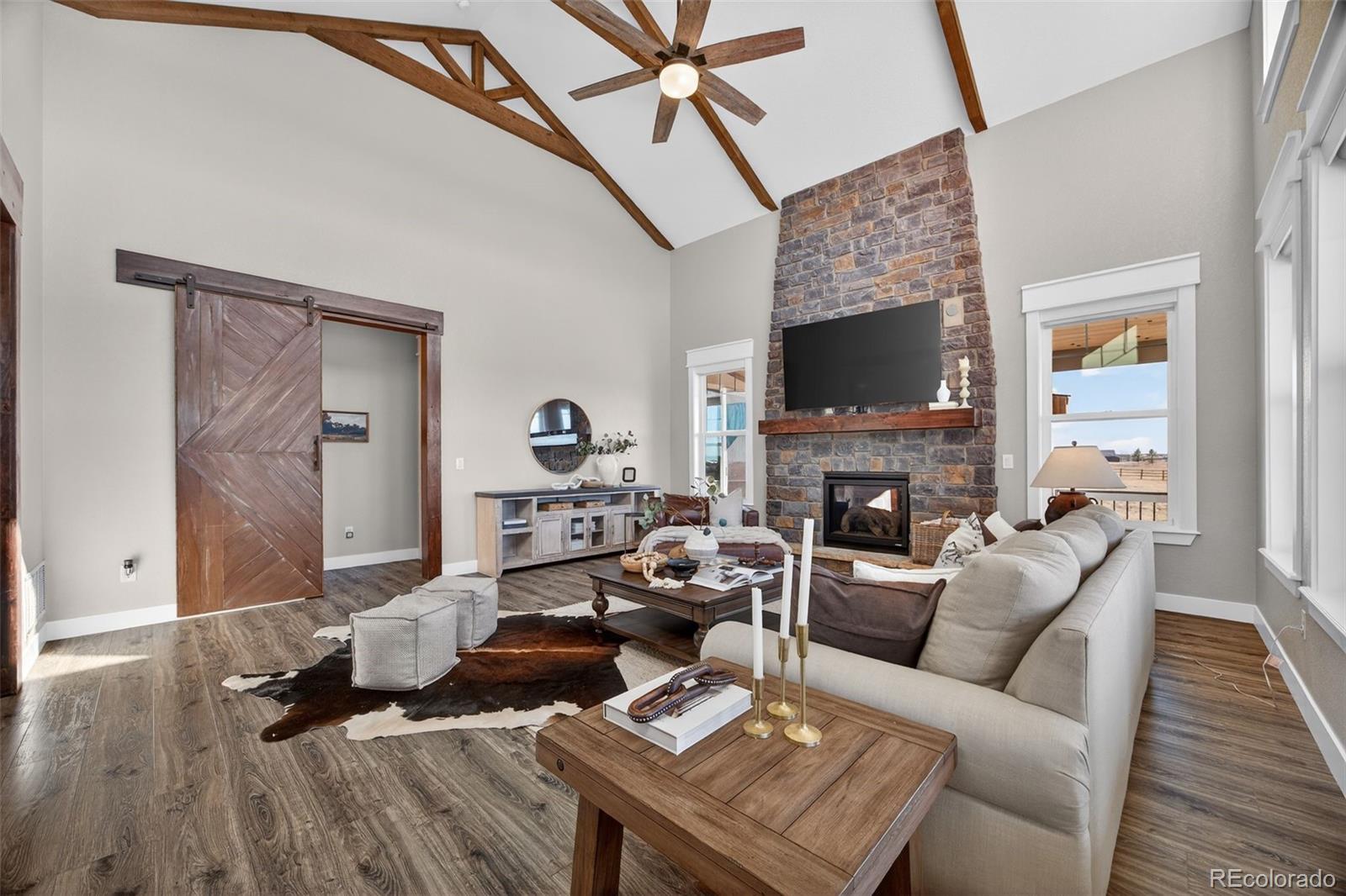 3444 Antelope Ridge Trail Parker, CO 80138 - Photo 8 of 50 a living room with furniture fireplace and a wooden floor