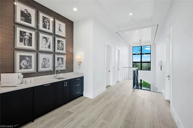 a hallway with a sink and cabinets