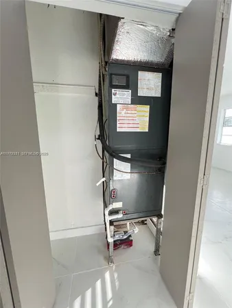 a room with water heater and car parked