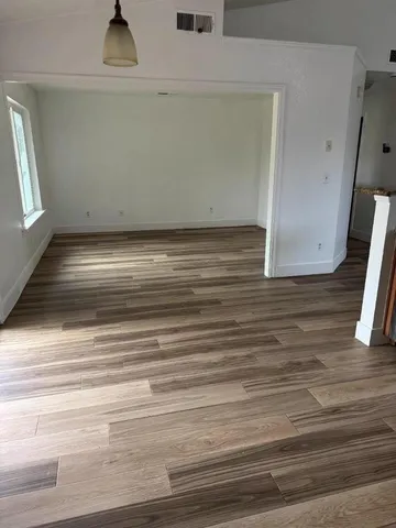 a view of a closet area with wooden floor
