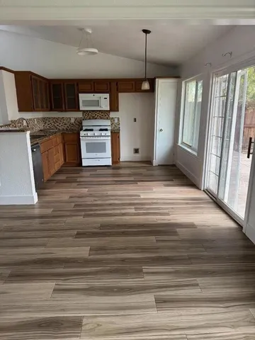 a view of kitchen and empty room