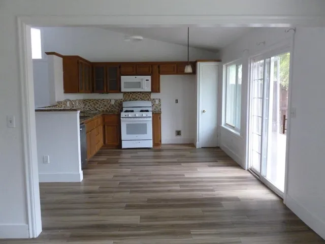 a view of a kitchen with a sink and a refrigerator