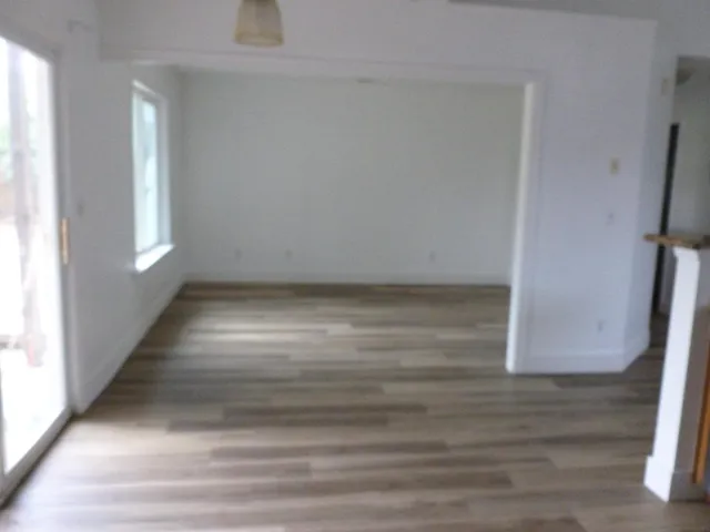 a view of room with window and hardwood floor