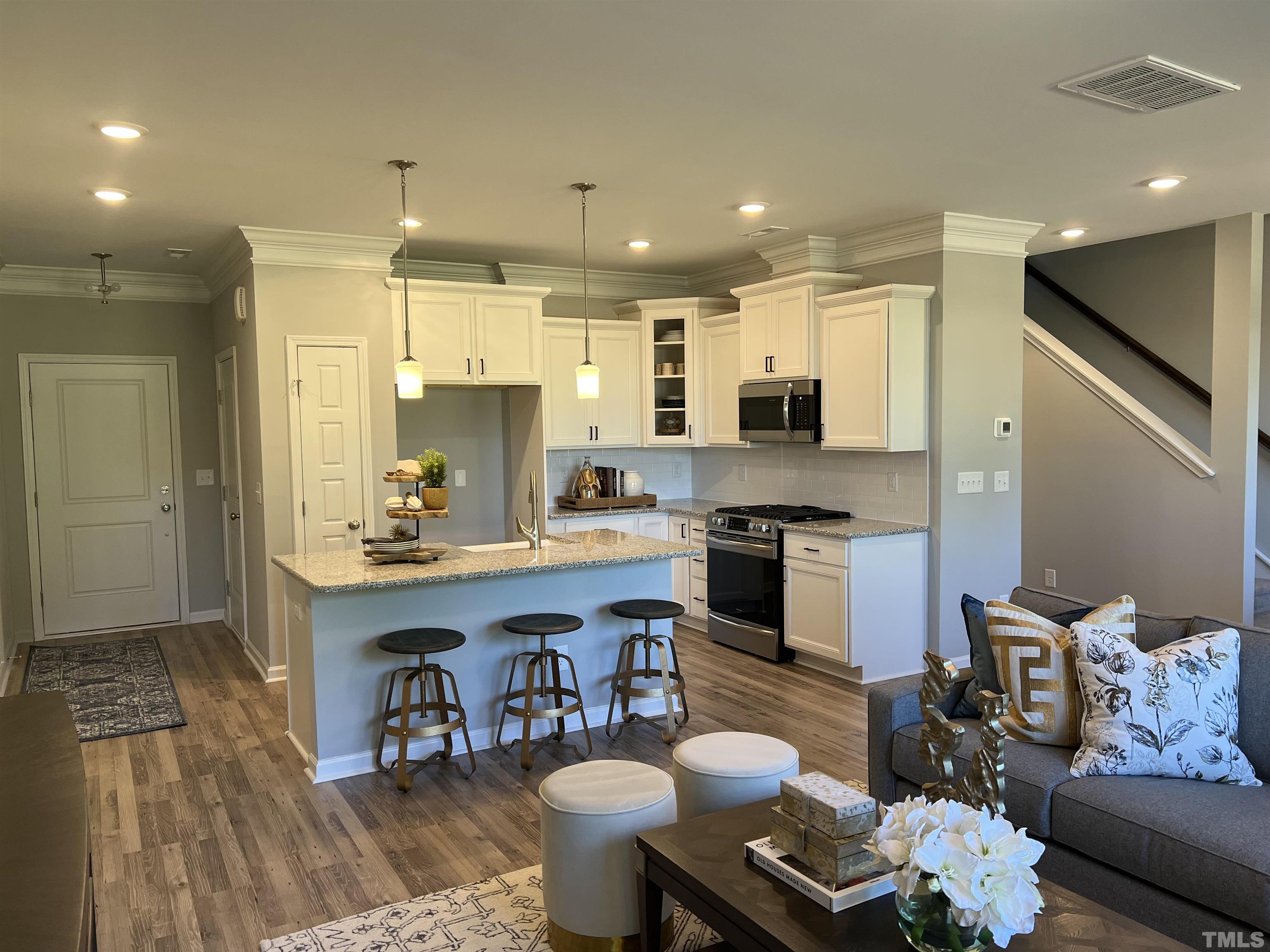 234 Shingle Oak Road Wake Forest, NC 27587 - Photo 4 of 6 a kitchen with a dining table chairs stove and kitchen view