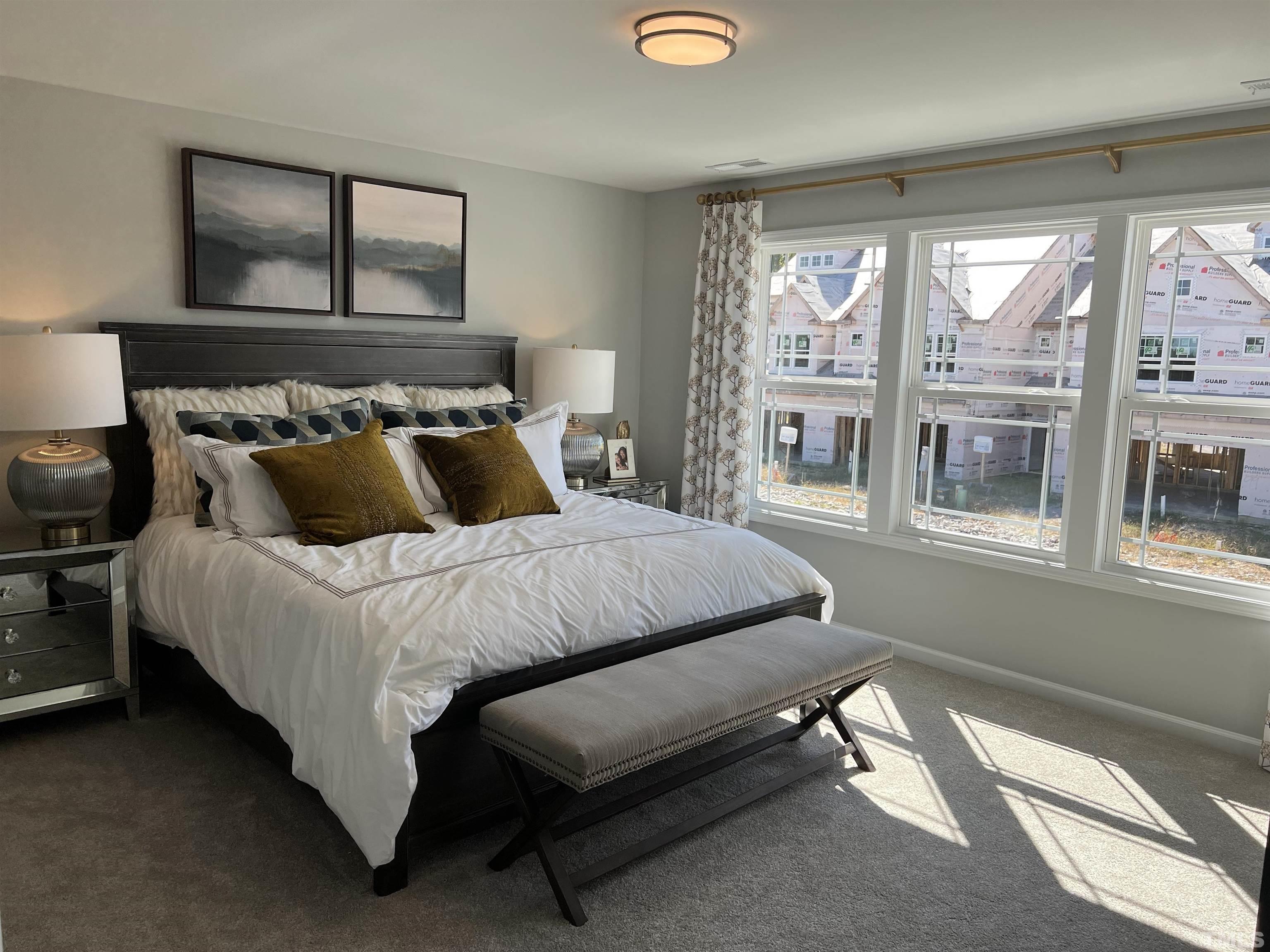 234 Shingle Oak Road Wake Forest, NC 27587 - Photo 5 of 6 a bedroom with a bed and glass window