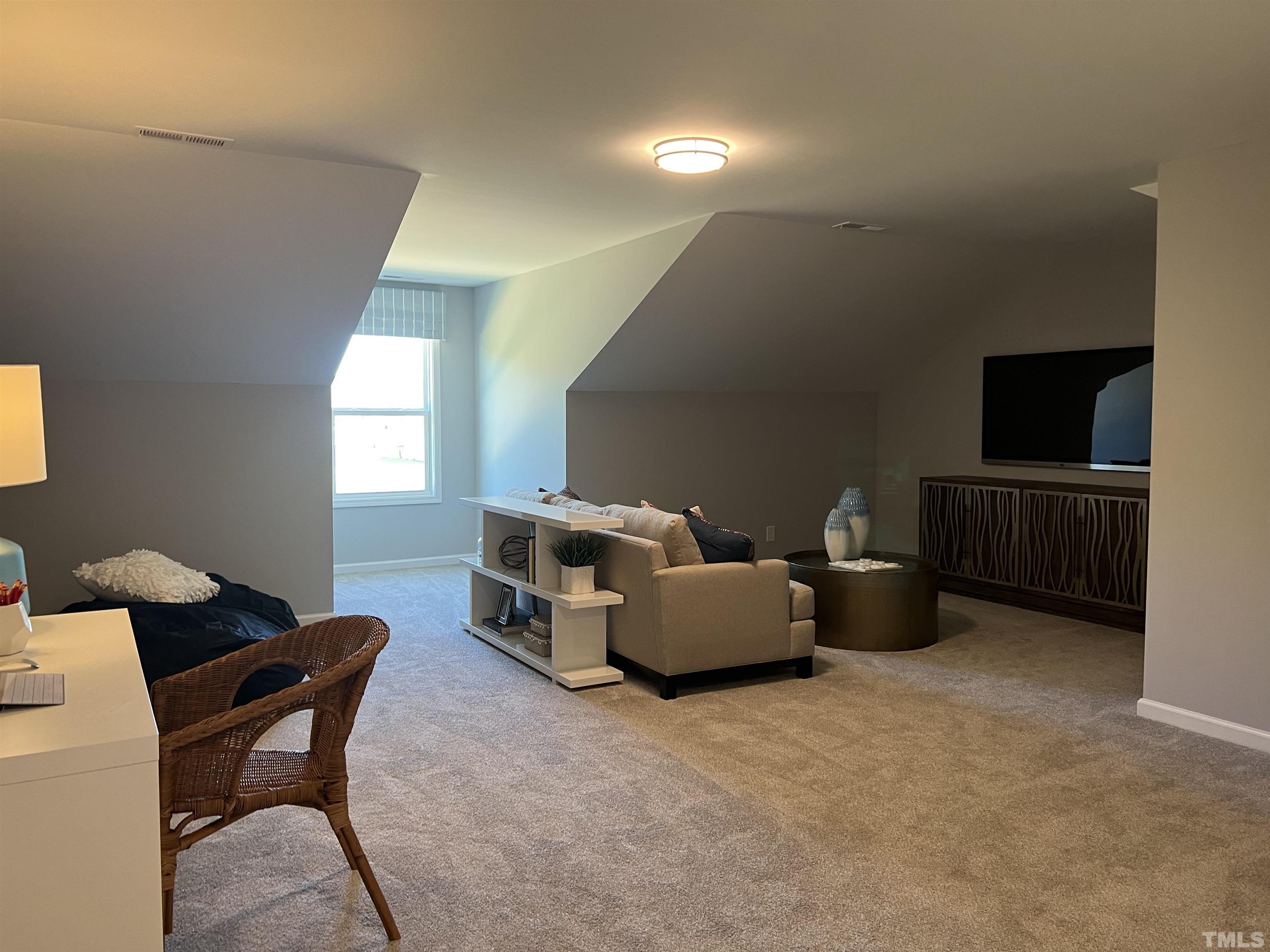 234 Shingle Oak Road Wake Forest, NC 27587 - Photo 6 of 6 a living room with furniture and a flat screen tv