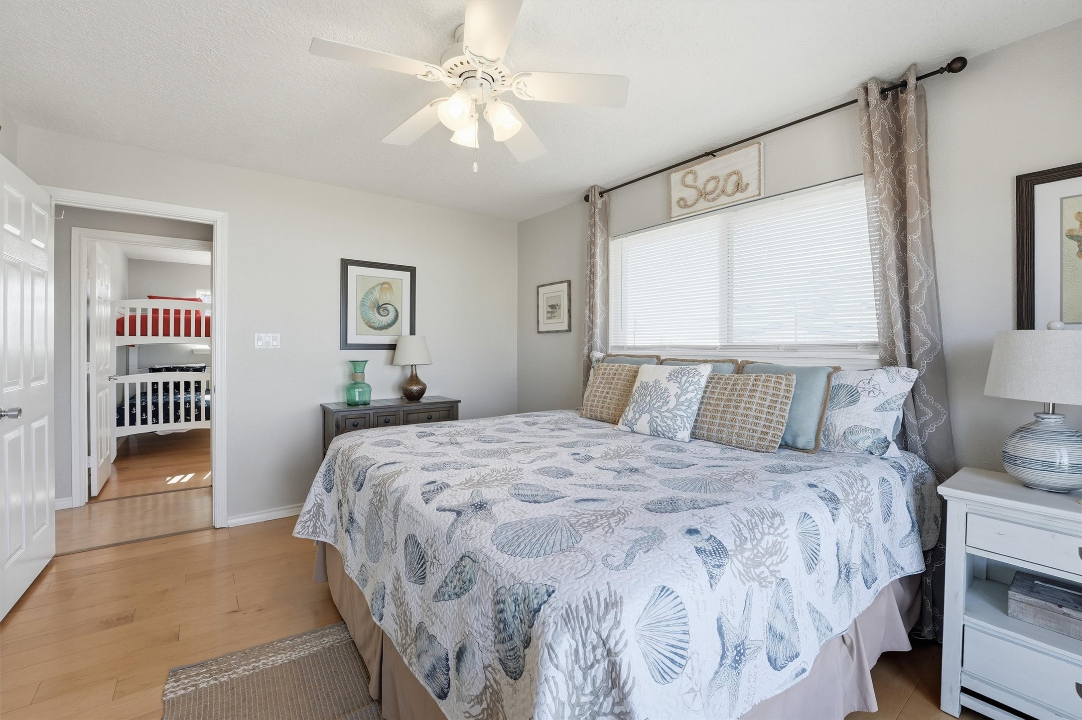 12902 John Reynolds Road Galveston, TX 77554 - Photo 12 of 22 a bedroom with a large bed and a chandelier