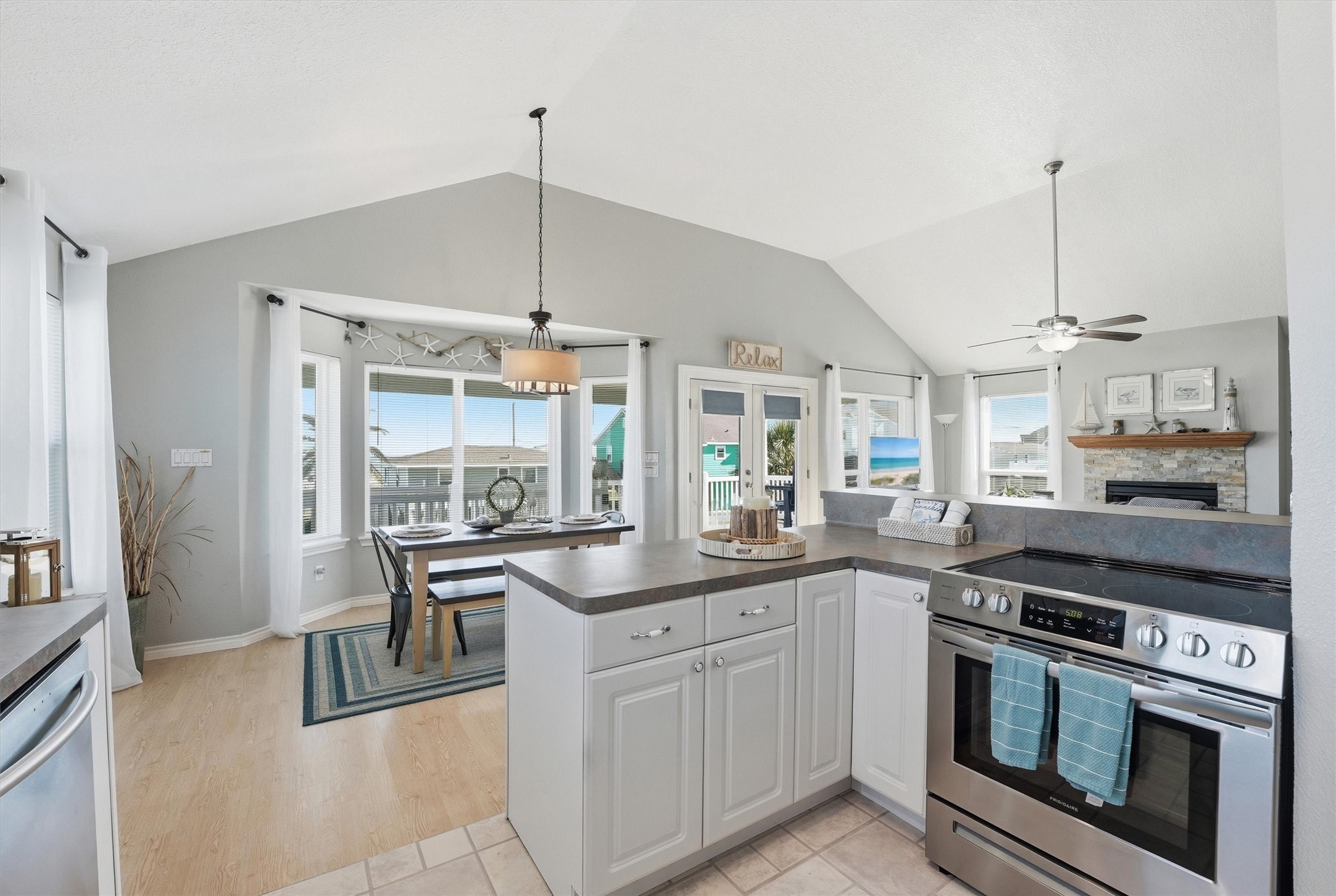 12902 John Reynolds Road Galveston, TX 77554 - Photo 7 of 22 a kitchen with stainless steel appliances granite countertop a stove a sink and a refrigerator