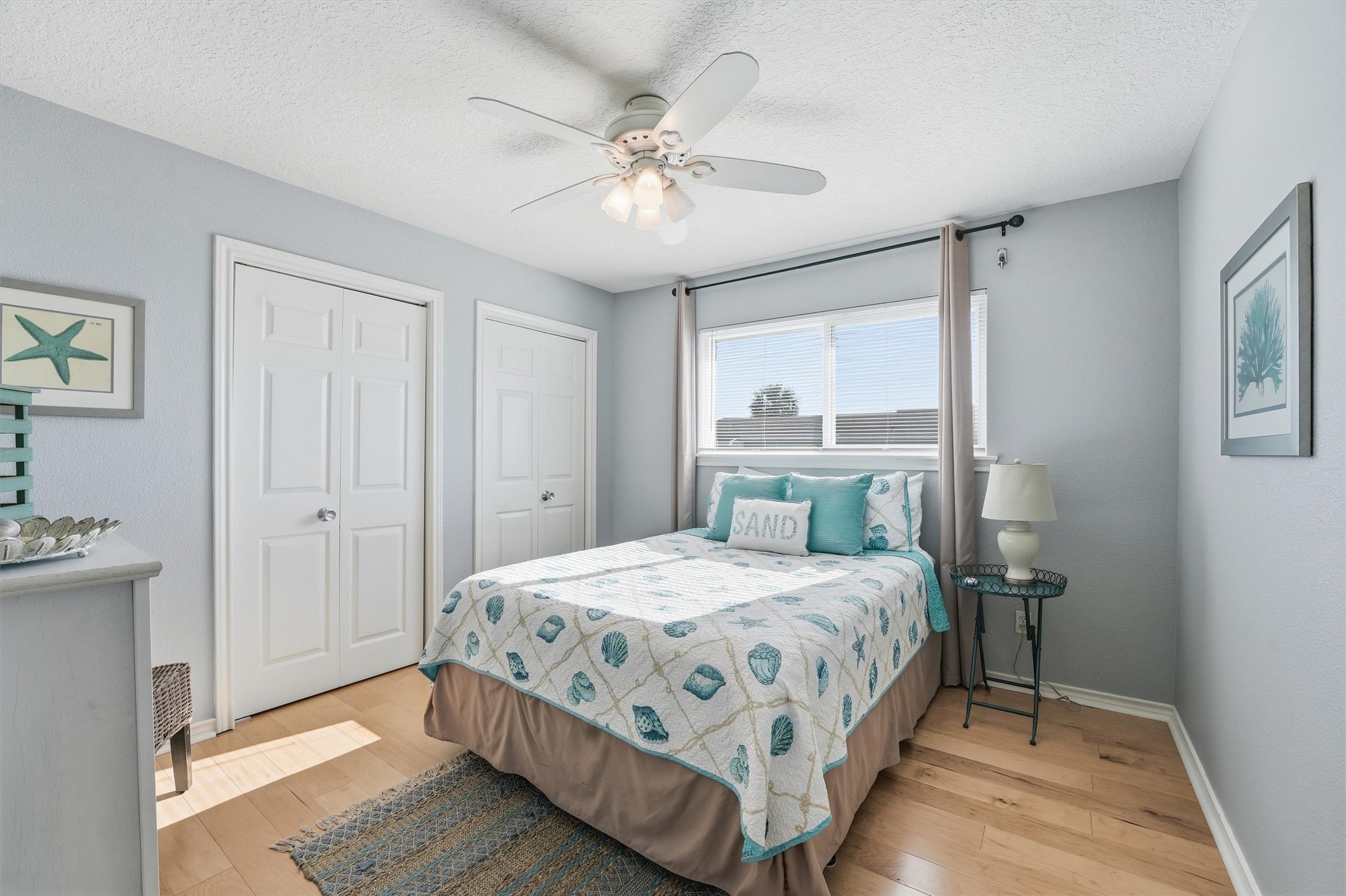 12902 John Reynolds Road Galveston, TX 77554 - Photo 8 of 22 a bedroom with a bed and a chandelier