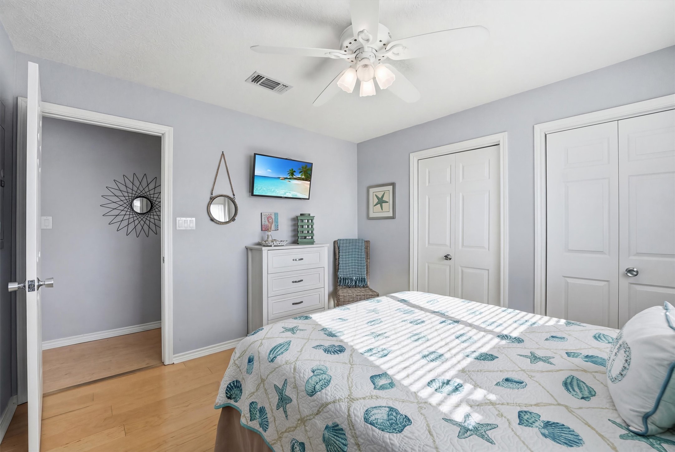 12902 John Reynolds Road Galveston, TX 77554 - Photo 9 of 22 a bedroom with a bed and a chandelier