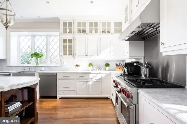 a kitchen with a sink a stove and cabinets