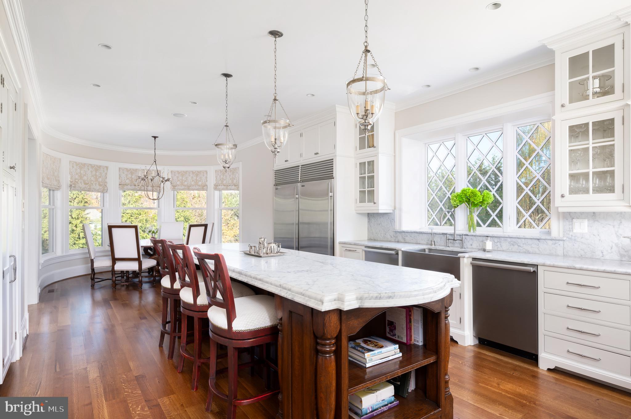 3031 Gates Road Northwest Washington, DC 20008 - Photo 18 of 50 a view of a dining room and livingroom with furniture wooden floor a chandelier