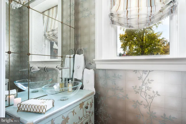 a bathroom with a granite countertop sink a mirror and a shower