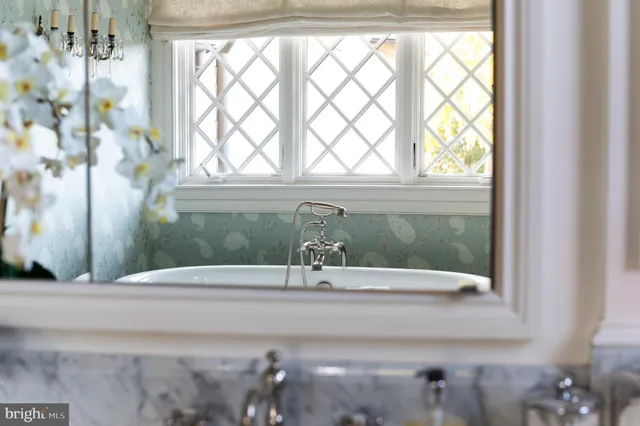 a bedroom with a bed and a table in it with window