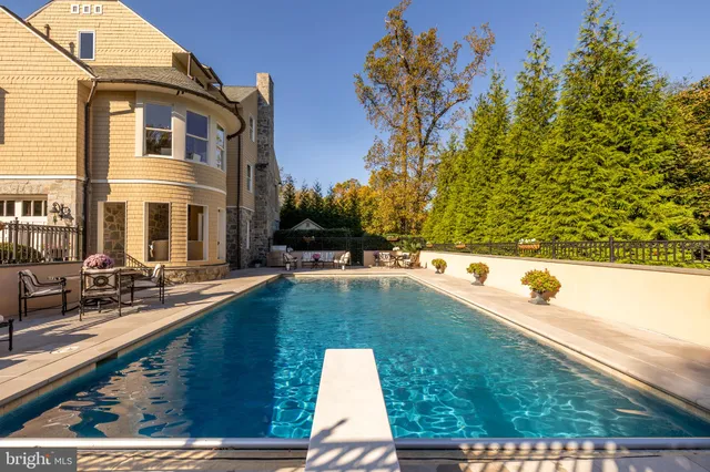 a swimming pool with outdoor seating and yard