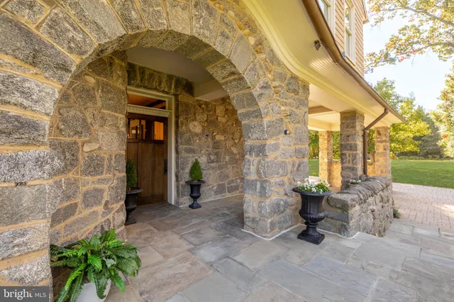 a front view of a house with outdoor seating