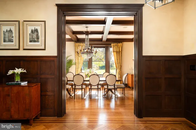 a dining room with glass door and furniture