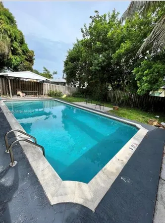 a view of a swimming pool with a yard