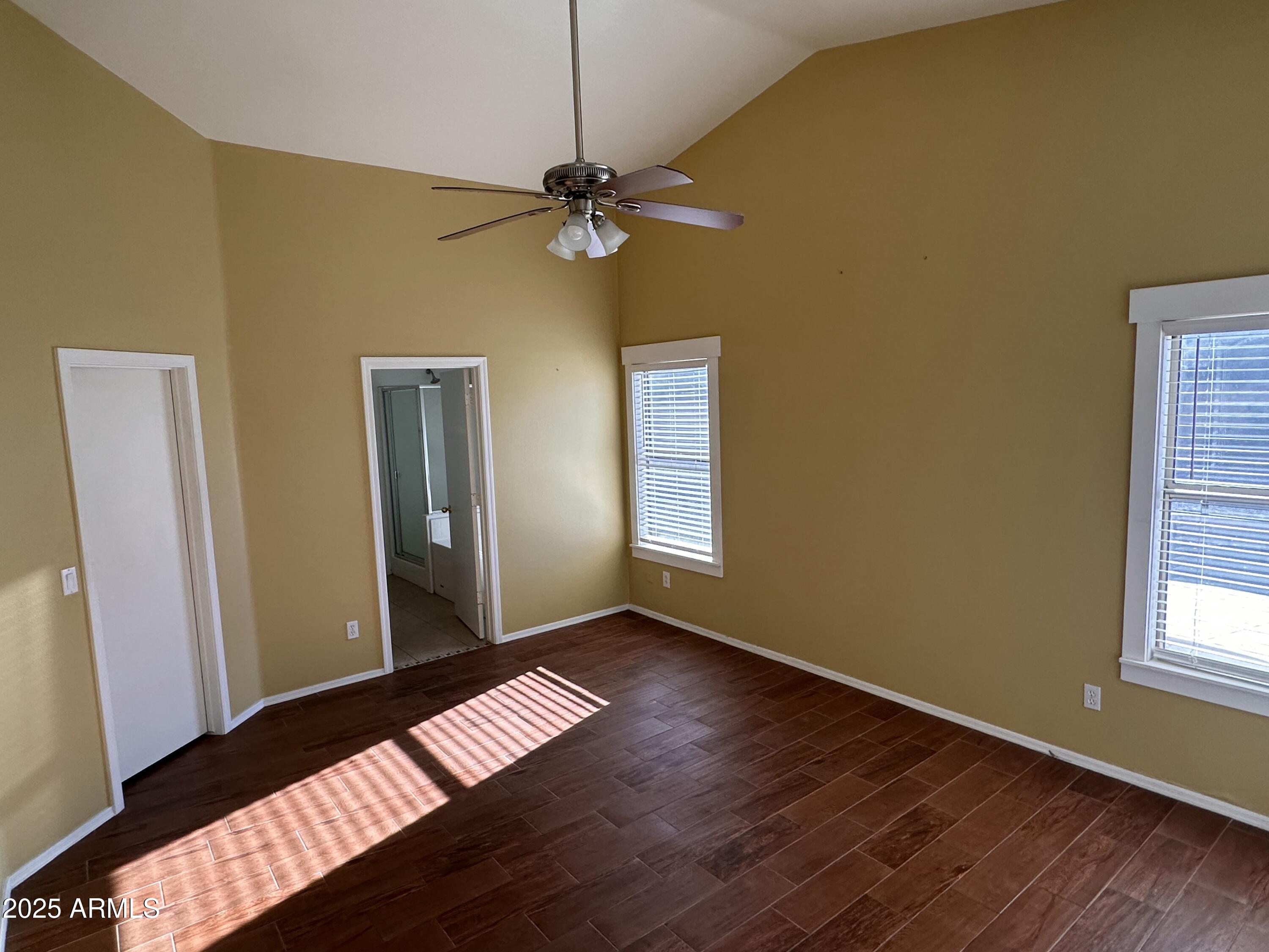 25412 North 40th Lane Phoenix, AZ 85083 - Photo 16 of 19 a view of an empty room with window and wooden floor
