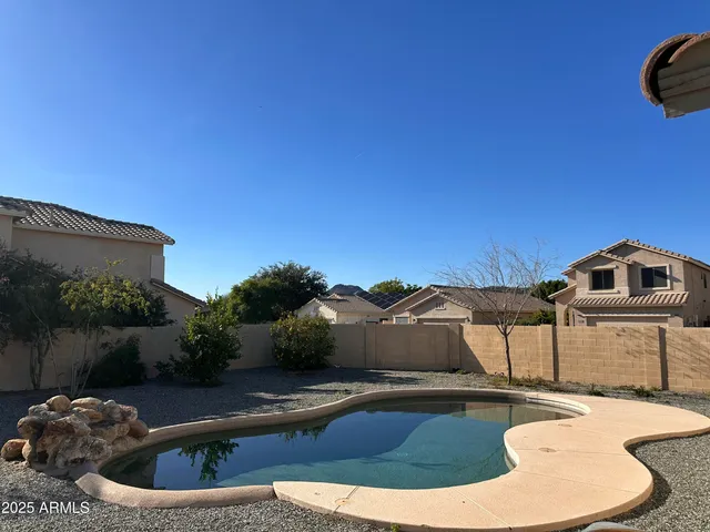 a view of a swimming pool with a yard