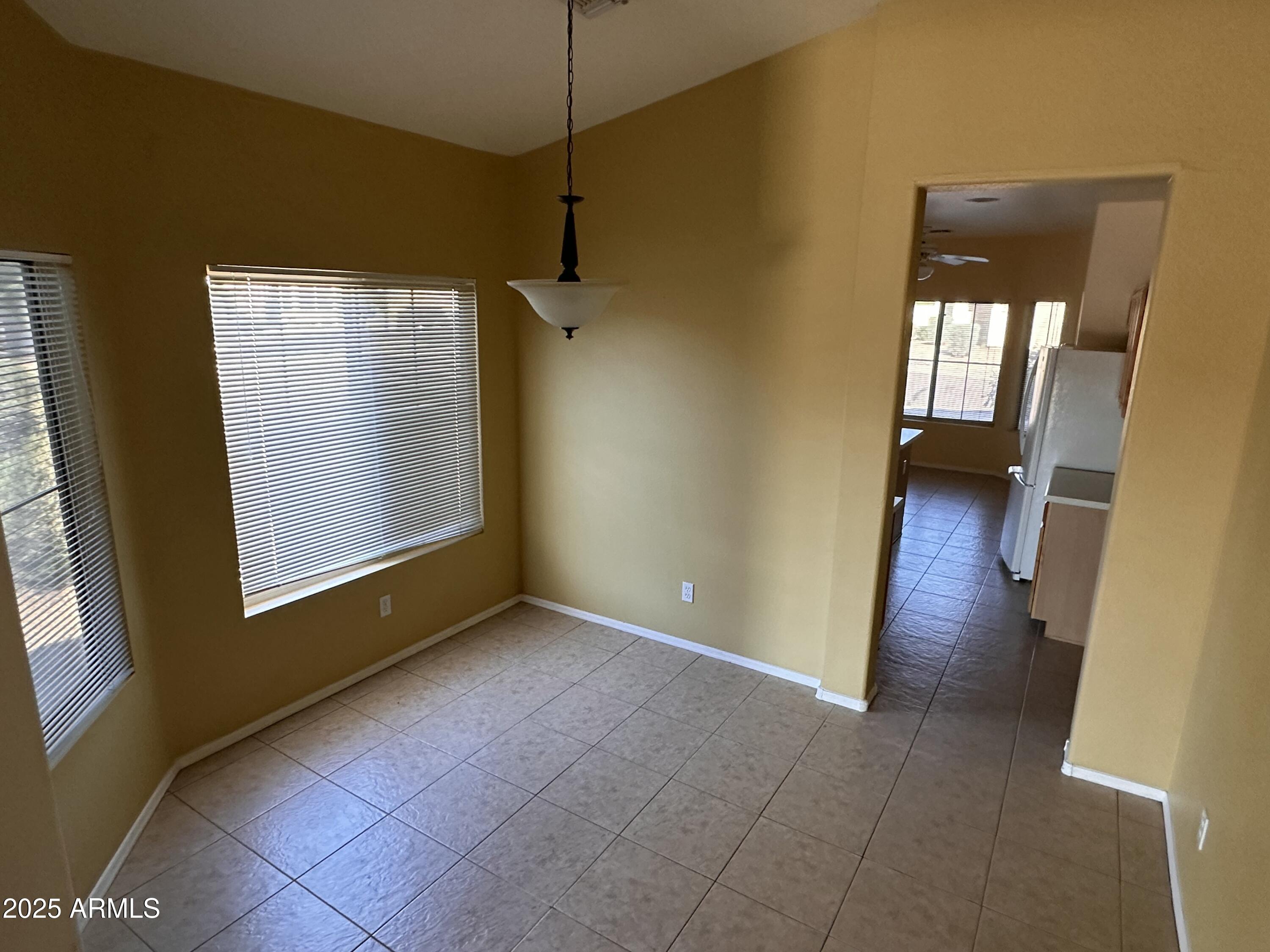 25412 North 40th Lane Phoenix, AZ 85083 - Photo 5 of 19 a view of an empty room with a window and wooden floor