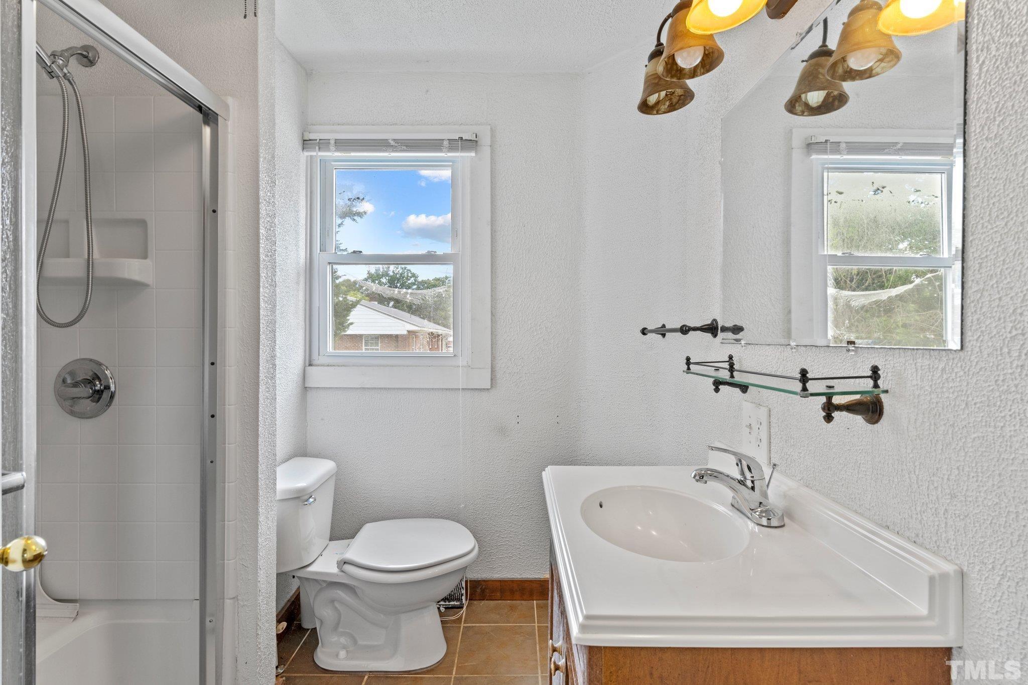 218 Oxford Road Roxboro, NC 27573 - Photo 13 of 16 a bathroom with a sink toilet and shower