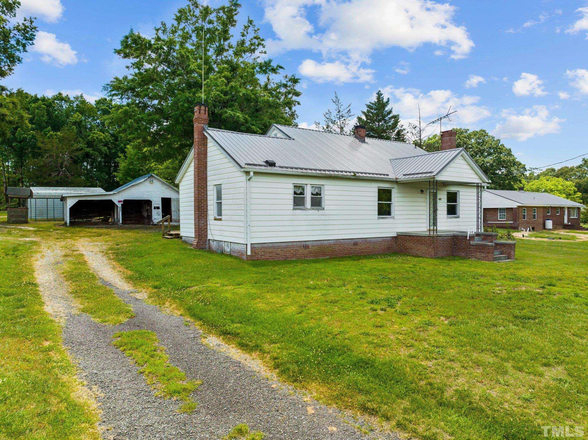 218 Oxford Road Roxboro, NC 27573 - Photo 15 of 16 a view of a house with a backyard